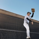 The catch of the day. Shot of a young man catching a ball at a baseball match.